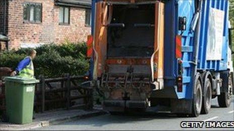 Rubbish truck outside a house