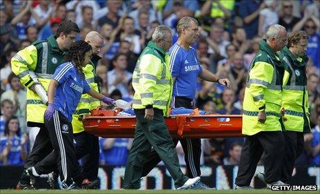 Drogba gets carried off the pitch