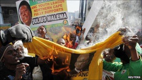 ANC supporters burning a Jacob Zuma T-shirt