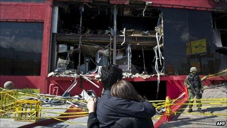 Relatives of victims cry in front of the Casino Royale, in Monterrey, on 27 August 2011