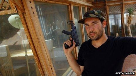 A rebel at a Gaddafi family home in Tripoli
