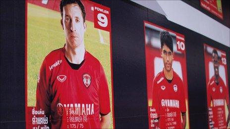 Posters showing Muang Thong players in their strip