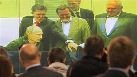 Journalists watch as Vladimir Putin (left) launches the Nord Stream pipeline in Vyborg, Russia, 6 September