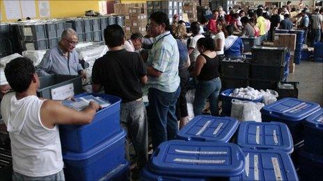 Election workers prepare ballots with a week to go to the presidential poll