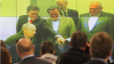 Journalists watch as Vladimir Putin (left) launches the Nord Stream pipeline in Vyborg, Russia, 6 September