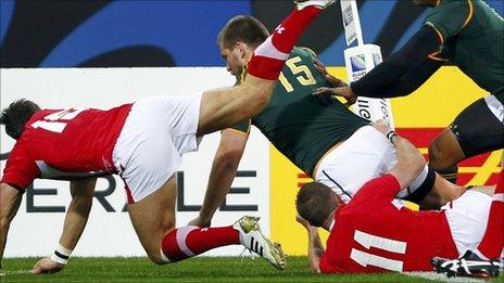 Frans Steyn barges through Shane Williams (11) and James Hook to score for South Africa