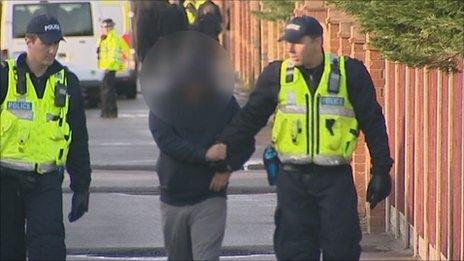 Man being led by police