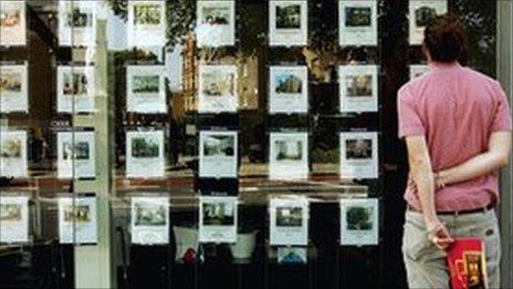 Man standing outside estate agent