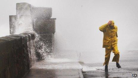A man walks on the sea front at Largs, on the Firth of Clyde in Ayrshire