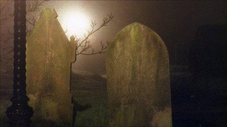 Headstones at night