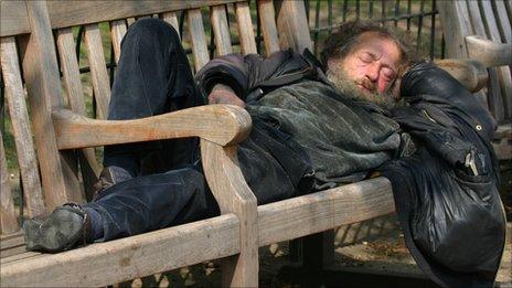 Rough sleeper on park bench