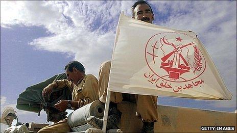 An MEK member displays the group's flag