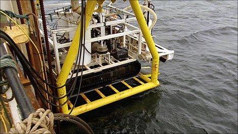 ROV being lowered from barge