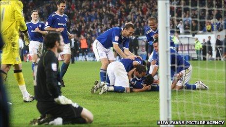 Cardiff players mob Paul Quinn after his penalty shoot-out winner against Leicester