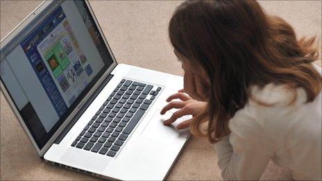 Young girl browses the internet on a laptop computer