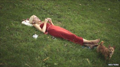 Woman wearing headphones in park
