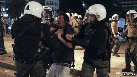 Greek police detain a protester in Athens, 27 September