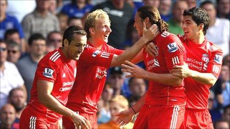 Jubilant Liverpool players congratulate Andy Carroll after the opening goal