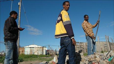 The Haji sort through the rubble of their shop in Motherwell, Port Elizabeth