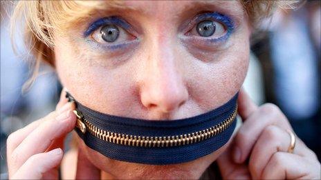 Protester with zip over her mouth, Rome (5 Oct 2011)