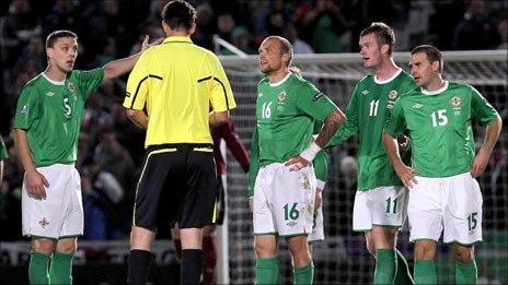 NI players confront the referee