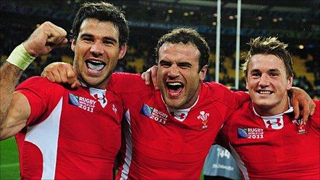 Mike Phillips, Jamie Roberts and Jonathan Davies celebrate Wales' win