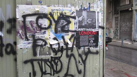 Graffiti and a sign in Athens