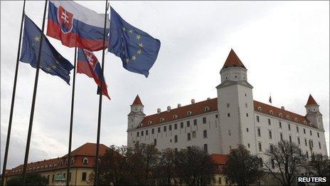 Slovak and European Union flags fly next to Bratislava Castle