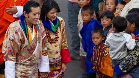 King Jigme Khesar Namgyel Wangchuck, 31 and Queen Jetsun Pema, 21, greet well wishers as they walk out after their marriage ceremony is completed on October 13, 2011 in Punakha, Bhutan