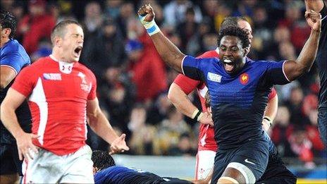 Wales winger Shane Williams despairs as France back rower Fulgence Ouedraogo celebrates the final whistle