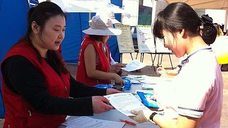 Jong-sun Woo (left) working on a mental health awareness street campaign