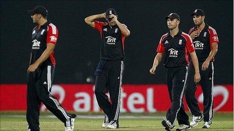 Alastair Cook (centre) trudges off with his team-mates in Delhi