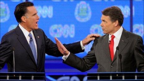 Mitt Romney (L) and Rick Perry debate in Las Vegas on 18 October 2011