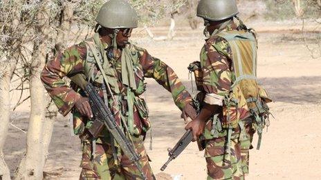 Kenyan soldiers talk as they prepare to advance near Liboi in Somalia, on 18 October 2011, near Kenya's border town with Somalia