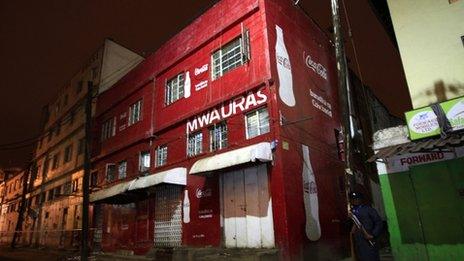 A police officer stands outside a club after an explosion in Kenya's capital Nairobi on 24 October 2011