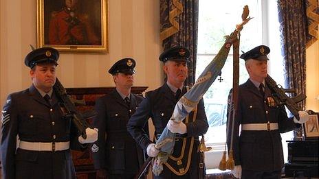 201 Squadron standard accompanied by former members of the squadron at Guernsey's Government House