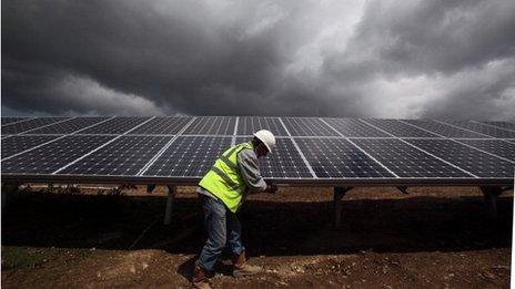 A man installing solar panels