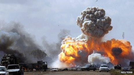 Vehicles belonging to pro-Gaddafi forces explode after a Nato airstrike on a road between Benghazi and Ajdabiyah on 20 March 2011