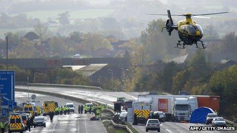 A police helicopter takes off from an area on the M5 motorway near Taunton in Somerset where an accident occurred on 5 November 5 2011