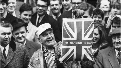 19th March 1968: A man holds up a plastic carrier bag declaring "I'm Backing Britain"