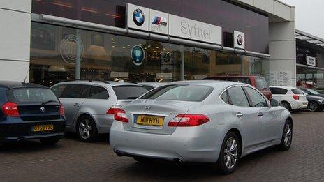 Infiniti parked outside a BMW dealership