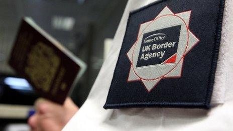 UK border official checking a passport