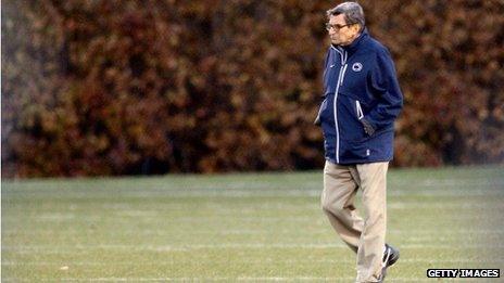 Joe Paterno walks across a field