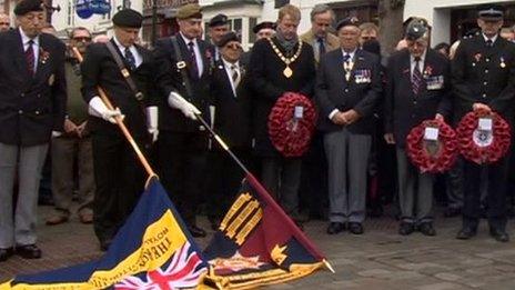 Dignitaries stand by the war memorial in Royal Wootton Bassett