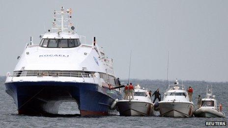 Coastguard boats rescue passengers from the Kartepe ferry