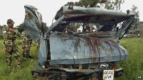 Security personnel inspect a vehicle that was destroyed in a landmine blast in Chhattisgarh state's Dantewada district, 7 Oct 2011