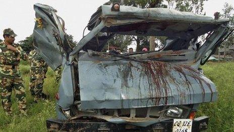 Security personnel inspect a vehicle that was destroyed in a landmine blast in Chhattisgarh state's Dantewada district, 7 Oct 2011