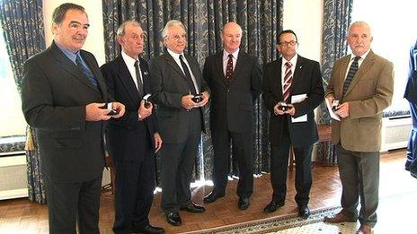 Veterans receiving badges from Guernsey's Lieutenant Governor