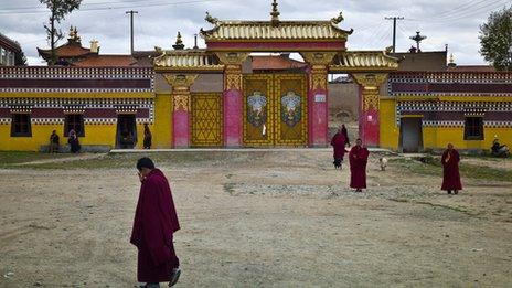 Monks outside an entrance to the Kirti monastery on 17 October 2011