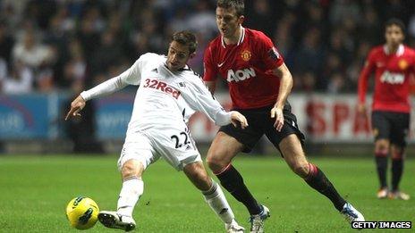 Angel Rangel under pressure from Michael Carrick during Swansea's 1-0 defeat to Manchester United